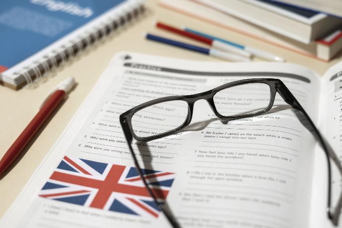 rozłożone okulary leżące na książce od języka angielskiego